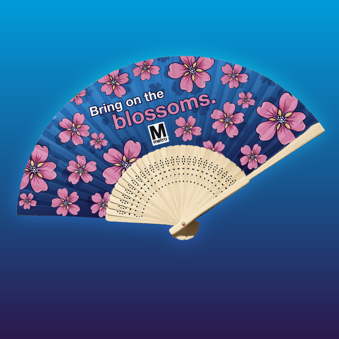 Blue paper folding fan with large pink cherry blossoms